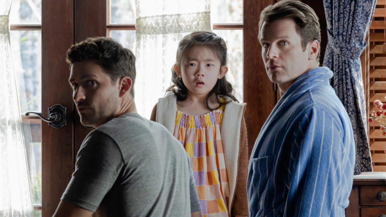  Ben Aldridge, Kristen Cui, and Jonathan Groff look back with shock in Knock at the Cabin. 