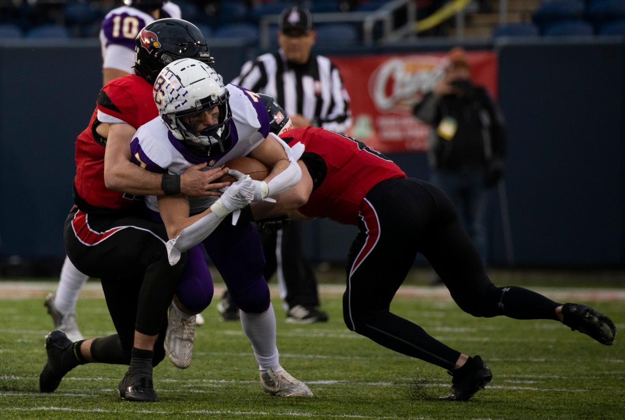 Bloom-Carroll junior running back Dylan Armentrout looks for running room during Friday's Division III state championship game at Tom Benson Hall of Fame Stadium. The Bulldogs fell short, 35-14.