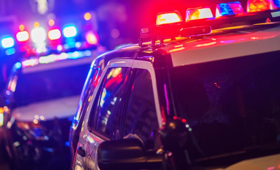 A stock photo of police vehicles with flashing lights.