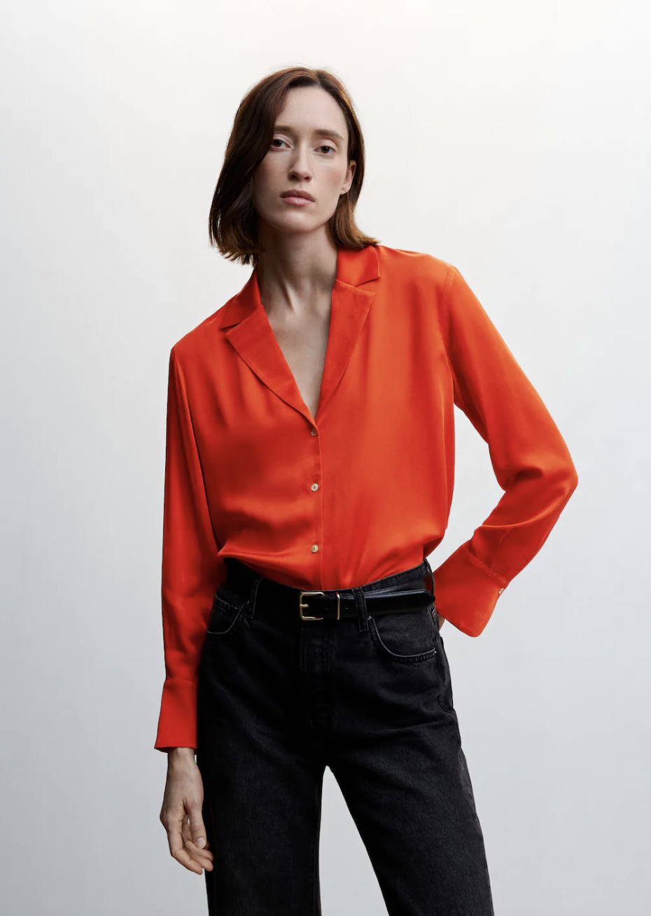 model wearing black pants and red button-up blouse, Lapels Flowy Shirt in coral red (photo via Mango)