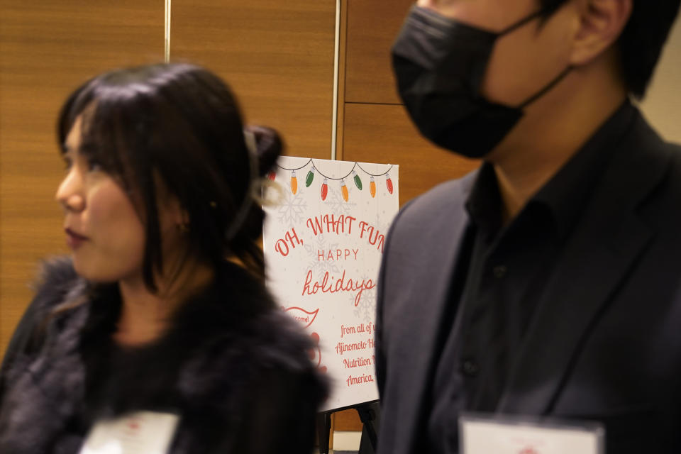 A holiday party sign welcomes employees and their guests to the Ajinomoto Health and Nutrition North America holiday dinner Friday, Dec. 9, 2022, in Schaumburg, Ill. Say goodbye to virtual wine tastings, and bust out the karaoke. Love them or hate them, company holiday parties are back. (AP Photo/Charles Rex Arbogast)