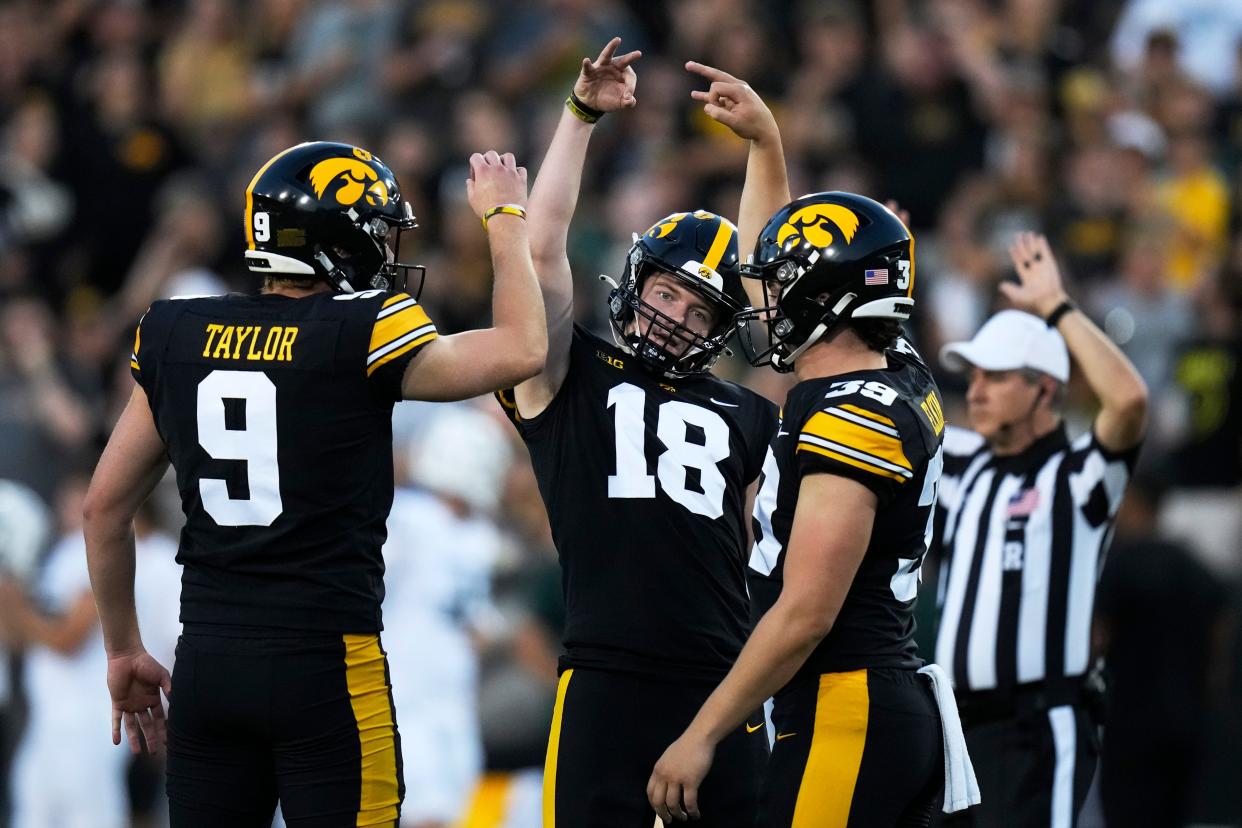 Iowa kicker Drew Stevens (18) celebrates with teammates Tory Taylor (9) and Luke Elkin (39) after kicking a field goal during the first half at Kinnick Stadium in Iowa City, Iowa, on Saturday, Sept. 30, 2023.