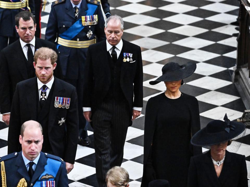 Prince Harry and Meghan Markle exit the Queen's funeral at Westminster Abbey.