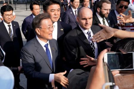 South Korean President Moon Jae-in greets his supporters near the White House in Washington, U.S., June 28, 2017. REUTERS/Yuri Gripas