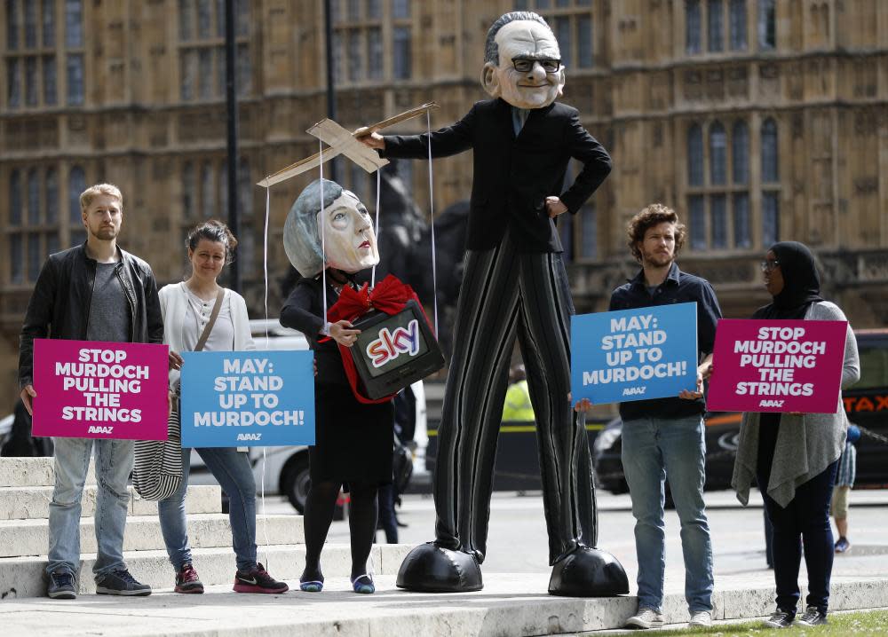 Campaigners from the community-based organisation Avaaz, with a character depicting Rupert Murdoch pulling the strings of Theresa May.