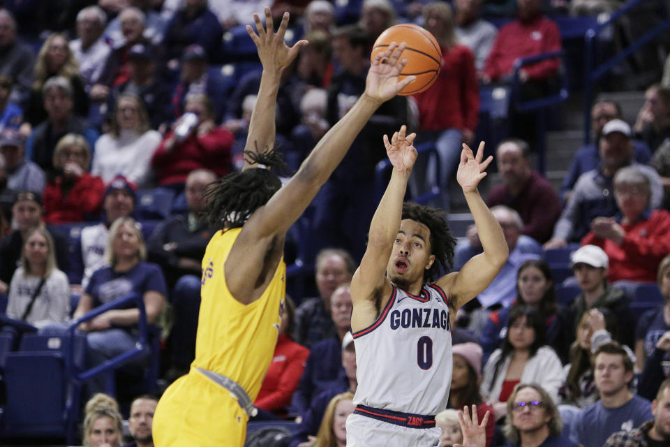 Gonzaga guard Ryan Nembhard (0) shoots while pressured by Cal State Bakersfield guard Kaleb Higgins during the first half of an NCAA college basketball game, Tuesday, Nov. 28, 2023, in Spokane, Wash. (AP Photo/Young Kwak)