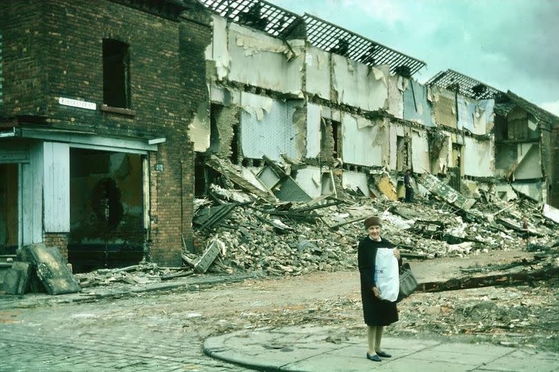 A picture by Stanley Horrocks of woman in the partially demolished Worcester Street Salford in 1976.