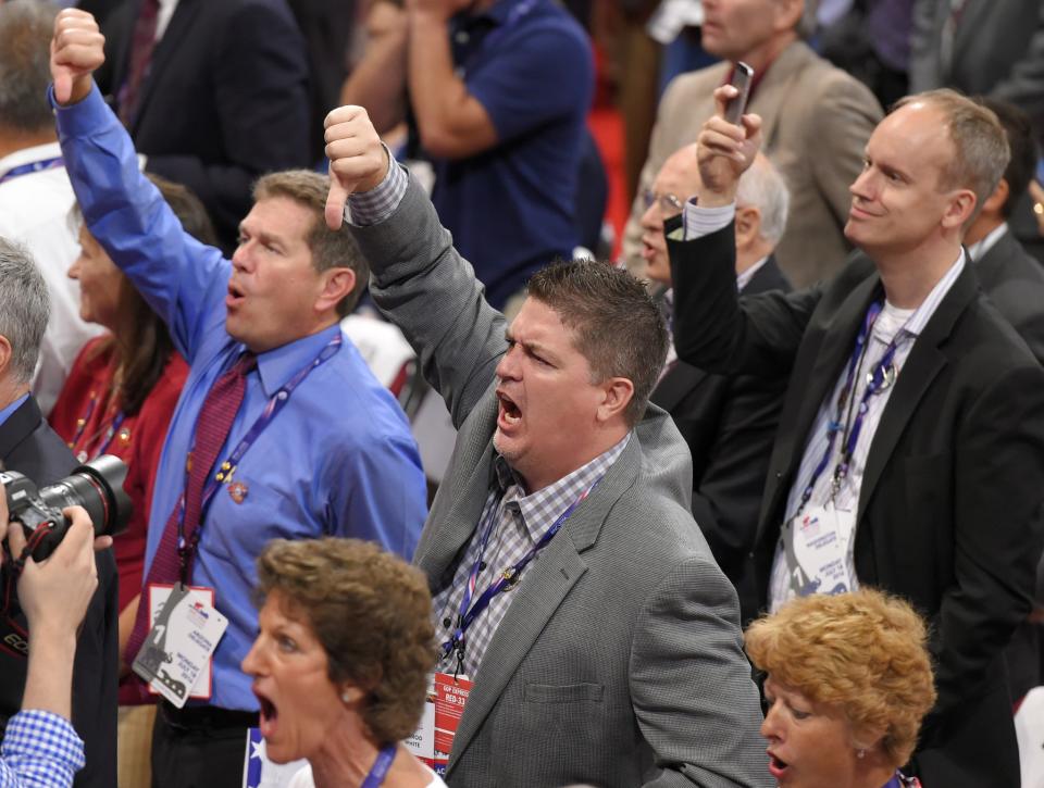 Delegates react as some call for a roll call vote on the adoption of the rules during the opening day of the Republican National Convention in Cleveland, Monday, July 18, 2016. (Photo: Mark J. Terrill/APl)