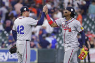 Atlanta Braves closing pitcher Jesse Chavez, left, high-fives right fielder Ronald Acuna Jr., right, after their win over the Houston Astros in a baseball game Monday, April 15, 2024, in Houston. All players wore No. 42 in honor of Jackie Robinson Day. (AP Photo/Michael Wyke)