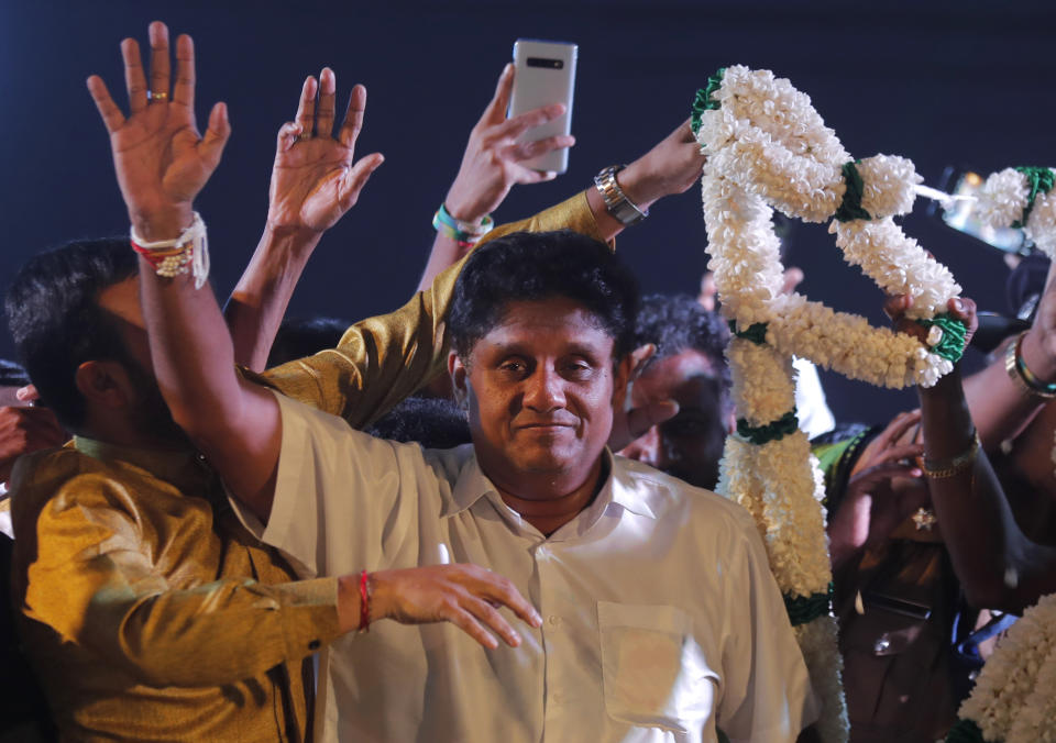 FILE - In this Monday, Nov. 11, 2019, file photo, presidential candidate of Sri Lanka's governing party Sajith Premadasa waves to supporters during a rally in Negombo, Sri Lanka. Premadasa entered the fray after an open rebellion against his party leader Prime Minister Ranil Wickremesinghe, rallying support by pledging to boost welfare programs and by embracing disgruntled party stalwarts. (AP Photo/Eranga Jayawardena, File)