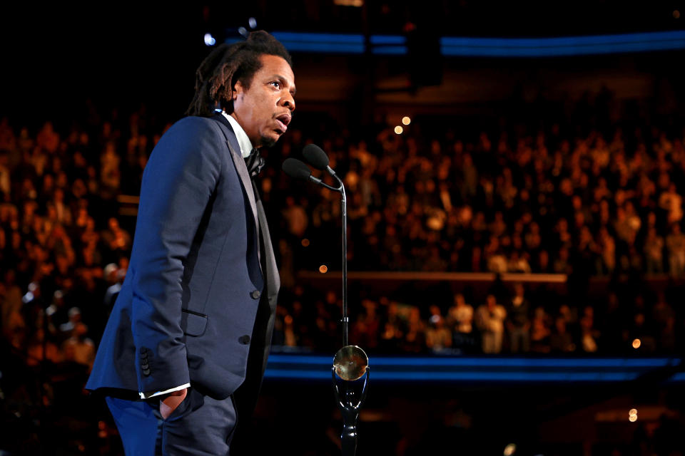 Jay-Z onstage wearing black suit 