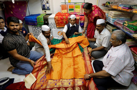 Dabbawalas, also known as tiffin carriers, purchase a saree and Kurta, traditional Indian clothing, as gifts for Britain's Prince Harry and Meghan Markle to mark the occasion of their wedding, in Mumbai, India, May 17, 2018. Picture taken May 17, 2018. REUTERS/Danish Siddiqui