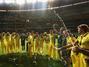 The Aussies with the trophy in the middle of the MCG.