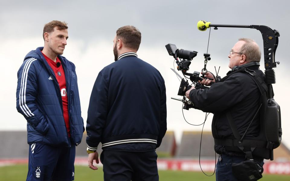 Nottingham Forest striker Chris Wood talks to a television crew ahead of an interview with John Percy at their training center in Nottingham
