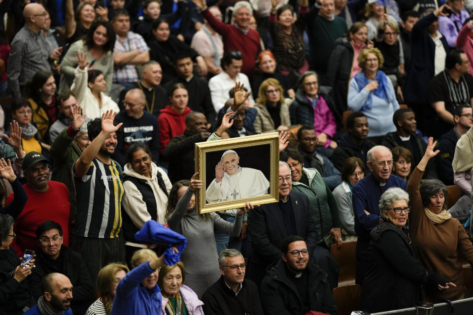Faithful hold a portrait of Pope Francis during his weekly general audience in the Paul VI Hall, at the Vatican, Wednesday, Feb. 28, 2024. (AP Photo/Andrew Medichini)