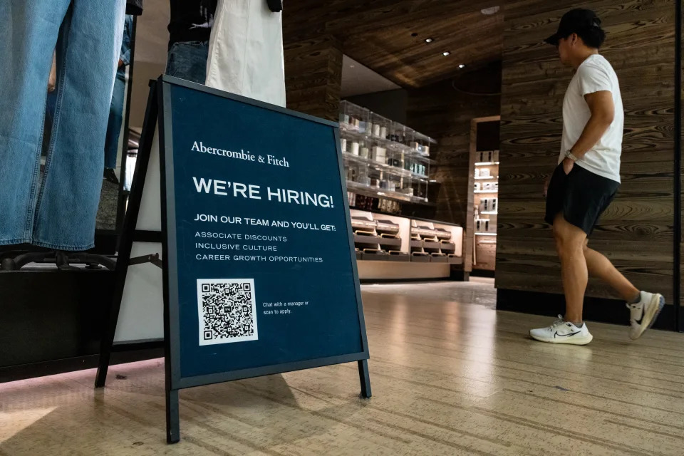 TYSONS, VA - AUGUST 22: A shopper walks past a hiring sign displayed in front of Abercrombie & Fitch at the Tysons Corner Center mall on August 22, 2024 in Alexandria, Virginia. According to reports, over 800,000 fewer jobs were created within the U.S. economy than originally reported in the 12-month period, 30% less than the previously reported 2.9 million from April 2023 through March, 2024. (Photo by Anna Rose Layden/Getty Images)