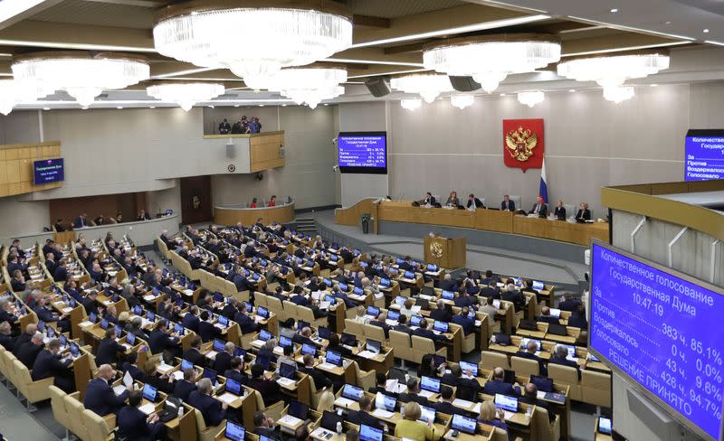Members of Russia's lower house of parliament attend a session to consider constitutional changes in Moscow