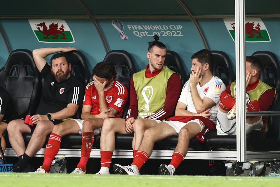 DOHA, QATAR - NOVEMBER 29: Gareth Bale of Wales sat in the dugout after being substituted during the FIFA World Cup Qatar 2022 Group B match between Wales and England at Ahmad Bin Ali Stadium on November 29, 2022 in Doha, Qatar. (Photo by James Williamson - AMA/Getty Images)