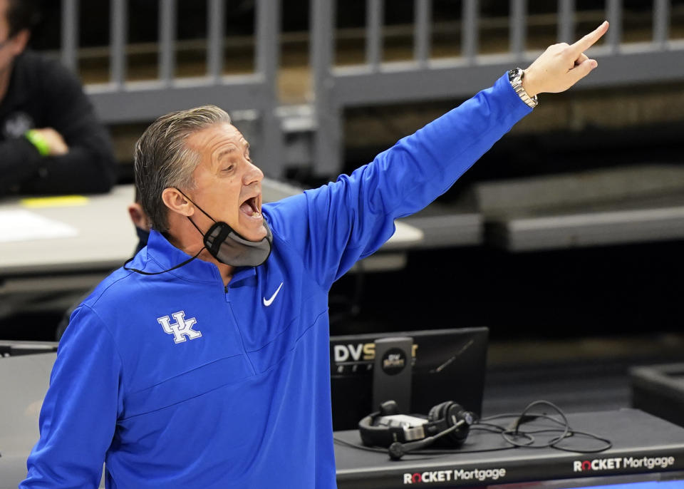 Kentucky head coach John Calipari yells instructions to players in the first half of an NCAA college basketball game against North Carolina, Saturday, Dec. 19, 2020, in Cleveland. (AP Photo/Tony Dejak)