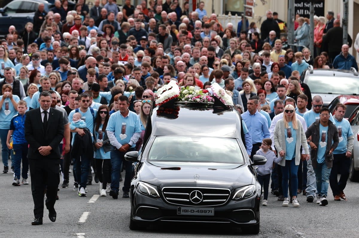 Huge crowds turn out for the funeral procession of Kiea McCann as it makes its way to the Sacred Heart Chapel in Clones, Co. Monaghan for her funeral  (PA)