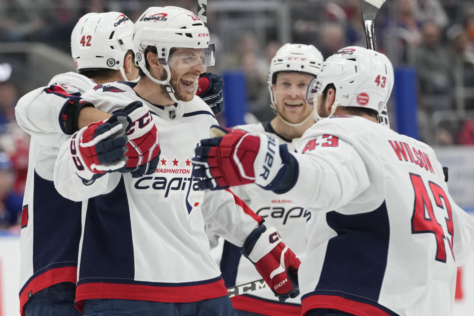Washington Capitals center Nic Dowd (26) celebrates with teammates after scoring against the New York Islanders during the third period of an NHL hockey game Saturday, March 11, 2023, in Elmont, N.Y. (AP Photo/Mary Altaffer)