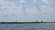 Excavators work on a Louisiana barrier island on Wednesday, July 28, 2021. A $102 million Louisiana Coastal Restoration and Protection Authority project is underway to add about 400 acres of beach, dune and marshland to Grand Terre Island. Weather permitting, contractors hope to finish in November. (AP Photo/Janet McConnaughey)