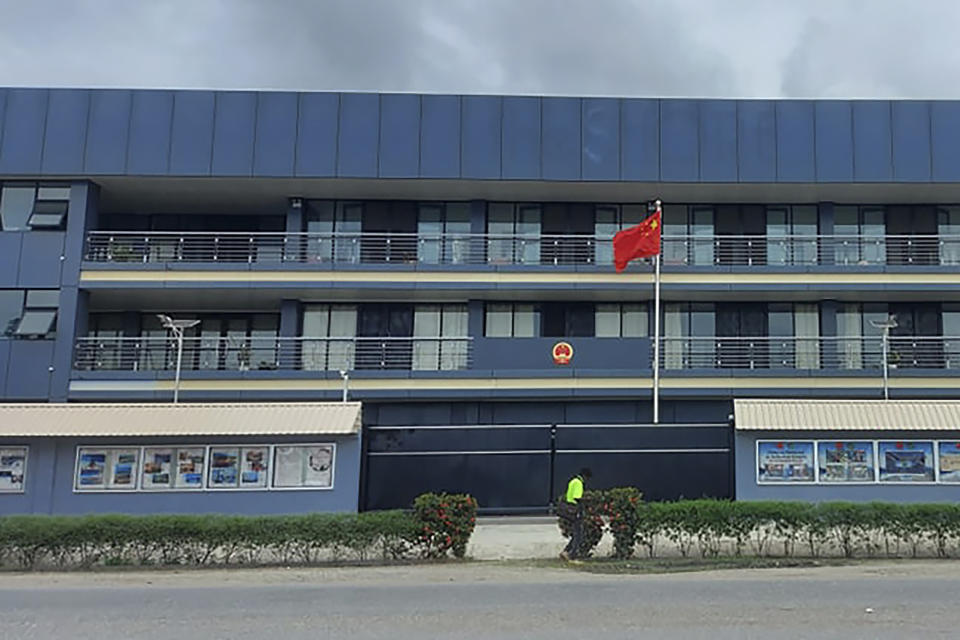 The Chinese national flag flies outside the Chinese Embassy in Honiara, Solomon Islands, Friday, April 1, 2022. Seeking to counter international fears over its new security alliance with China, the Solomon Islands said it won't allow China to build a military base there. (AP Photo/Charley Piringi)