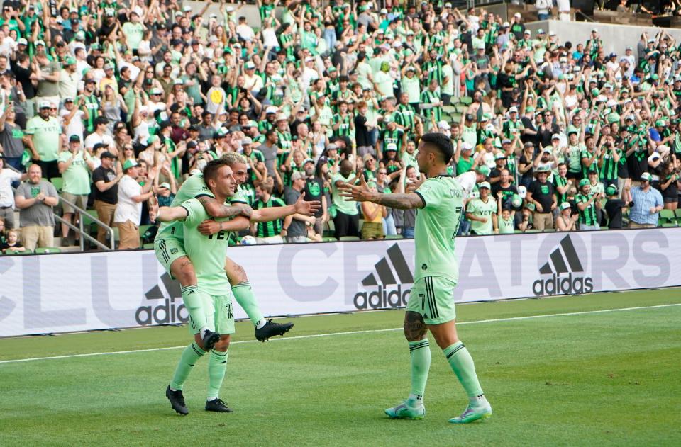 Austin FC midfielder Ethan Finlay, standing left, celebrates with Diego Fagúndez and Sebastián Driussi, right, after scoring a goal against Inter Miami in a 5-1 win in March. Finlay has two goals on the season, both in this game.