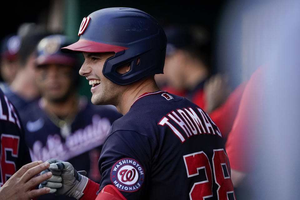 Washington Nationals' Lane Thomas (28) celebrates with teammates after hitting a two-run home run against the Cincinnati Reds during the third inning of a baseball game Friday, June 3, 2022, in Cincinnati. (AP Photo/Jeff Dean)