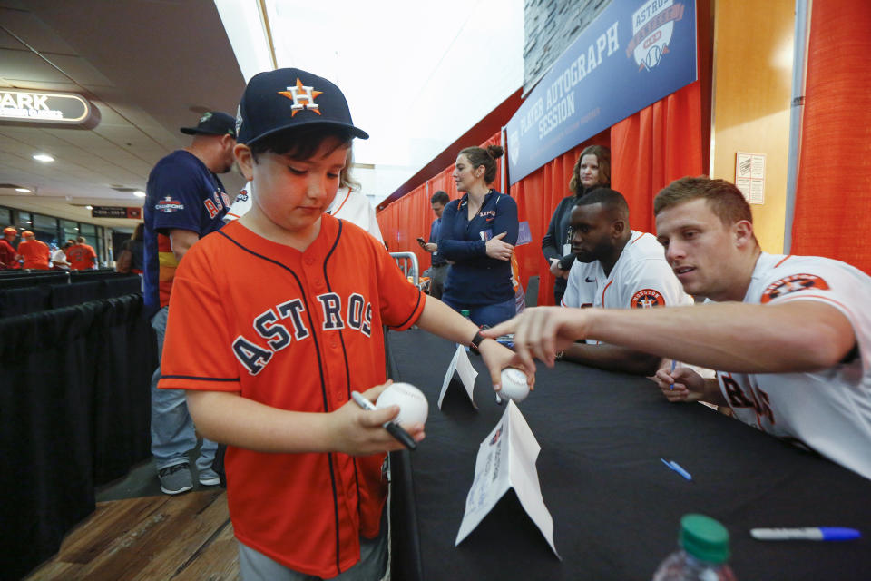 Houston Astros' Myles Straw, right, points to the baseball he signed for Noah Jackson, 9, during FanFest at Minute Maid Park on Saturday, Jan. 18, 2020, in Houston. (Steve Gonzales/Houston Chronicle via AP)