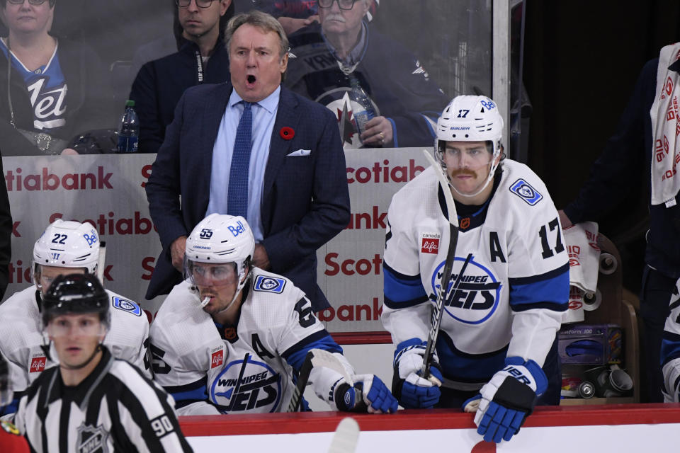Winnipeg Jets head coach Rick Bowness shouts instructions to his team as Adam Lowry (17) looks to get on the ice against the Chicago Blackhawks during the third period of an NHL hockey game in Winnipeg, Manitoba, Saturday, Nov. 5, 2022. (Fred Greenslade/The Canadian Press via AP)