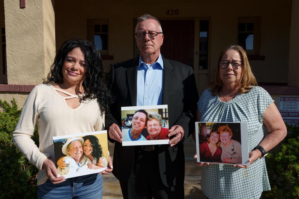 Denise Dinet (left), Troy Dinet and Peggy Brown pose with photos of them and their mother, Joyce Dinet, on March 17, 2023 in Phoenix.