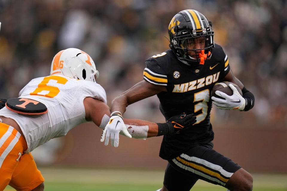 Missouri wide receiver Luther Burden III (3) runs past Tennessee linebacker Aaron Beasley (6) during the first half of an NCAA college football game Saturday, Nov. 11, 2023, in Columbia, Mo. (AP Photo/Jeff Roberson)