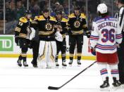 Jan 19, 2019; Boston, MA, USA; Boston Bruins goaltender Tuukka Rask (40) is helped off the ice by defenseman Charlie McAvoy (73) and right wing David Pastrnak (88) after he was in a collision with New York Rangers center Filip Chytil (72) during the first period at TD Garden. Mandatory Credit: Winslow Townson-USA TODAY Sports