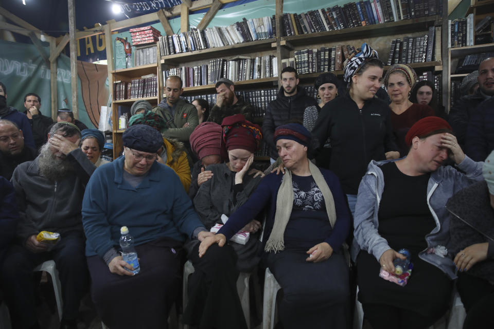 Mourners attend the funeral of Yehuda Dimentman, 25, who was killed in a shooting attack by a Palestinian gunman near the Jewish outpost of Homesh in the West Bank, Friday, Dec. 17, 2021. At least one Palestinian gunman opened fire Thursday night at a car filled with Jewish seminary students next to a West Bank settlement outpost, killing an Israeli man and lightly wounding two other people, Israeli officials said. (AP Photo/Moti Milrod)