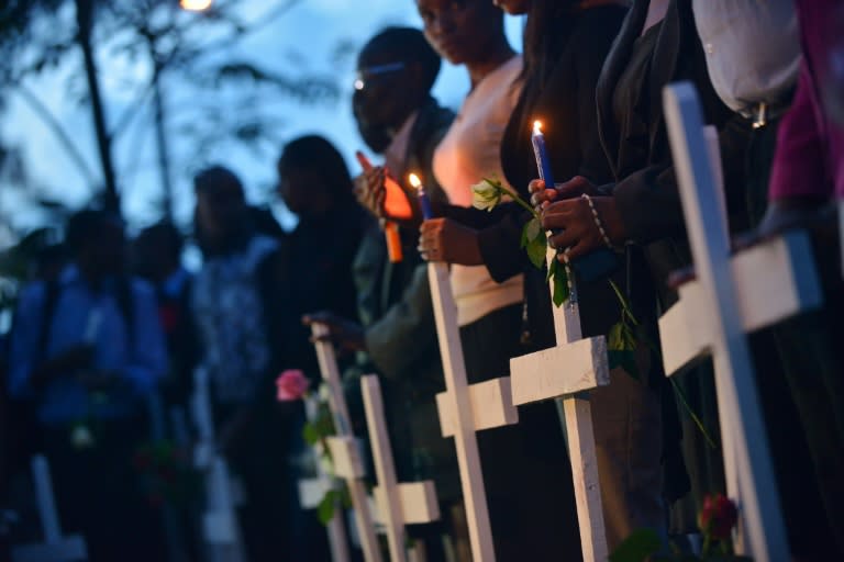 People stand with wooden crosses in Nairobi on April 7, 2015 during a vigil for victims of the attack on Garissa University in eastern Kenya