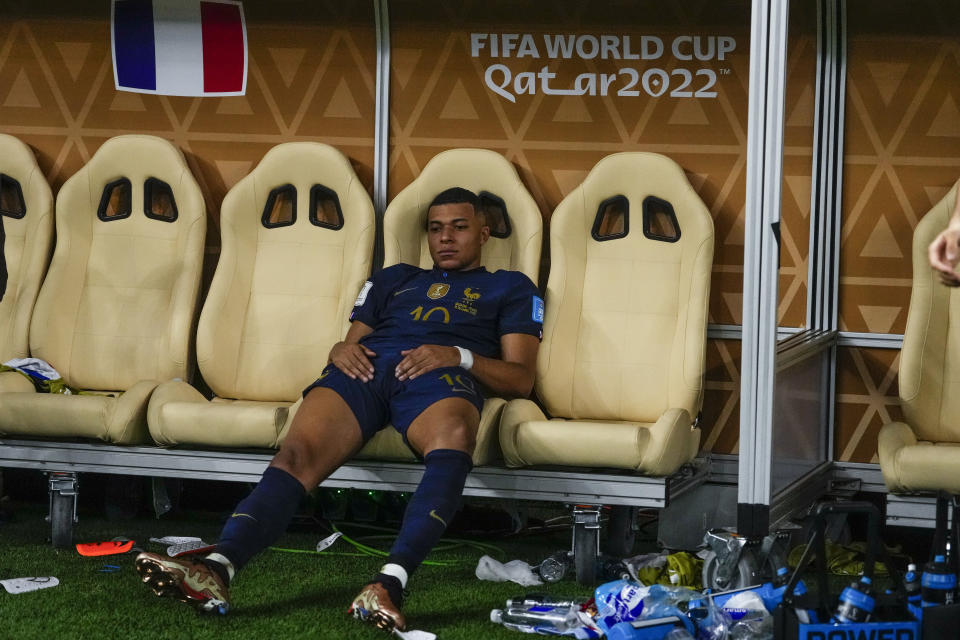 FILE - France's Kylian Mbappe sits on the bench at the end of the World Cup final soccer match between Argentina and France at the Lusail Stadium in Lusail, Qatar, Sunday, Dec.18, 2022. In France, Black players from the men's national team were targeted with horrific racial abuse online after they lost in last year's World Cup final. (AP Photo/Manu Fernandez, File)