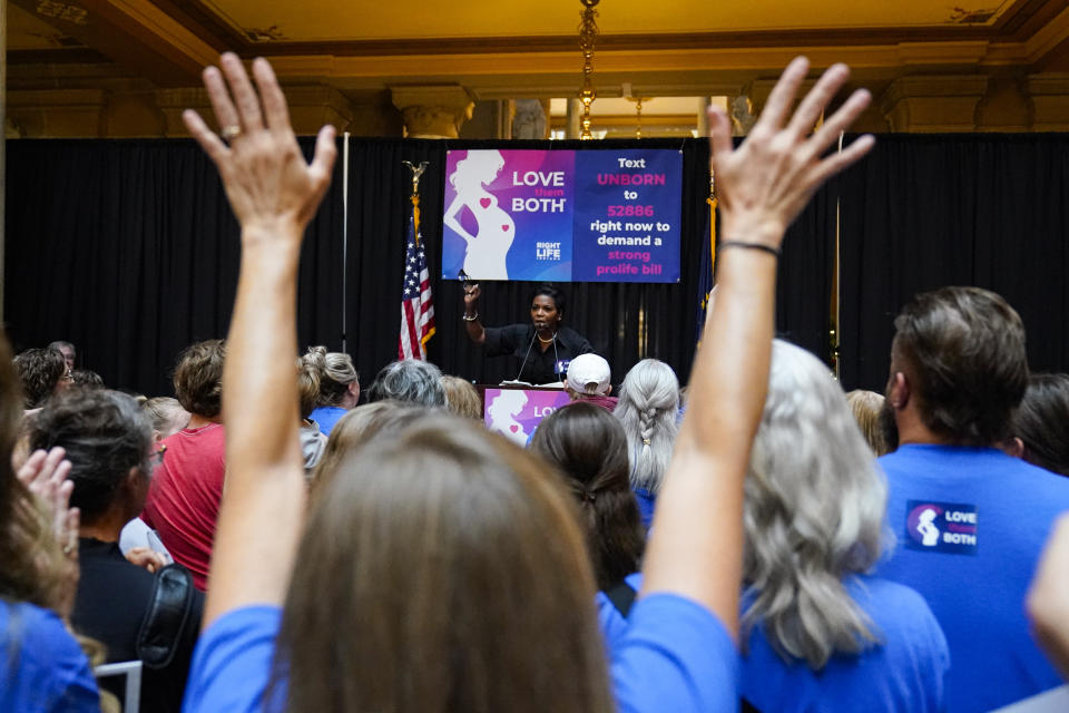 Anti-abortion supporters react as Angela Minter, president of Sisters for Life, speaks at a rally as the Indiana Senate Rules Committee met to consider a Republican proposal to ban nearly all abortions in the state during a hearing at the Statehouse in Indianapolis, Tuesday, July 26, 2022. (AP Photo/Michael Conroy)