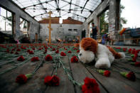 FILE PHOTO - A soft toy lies amid flowers in the burned-out gymnasium of Beslan's School No. 1, the scene of a 2004 hostage crisis, on the anniversary of the siege late September 1, 2007. REUTERS/Eduard Korniyenko/File Photo