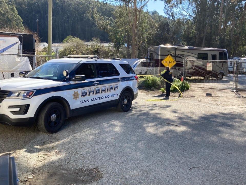 San Mateo County Sheriff’s deputy is pictured Tuesday putting up yellow tape outside the mountain mushroom farm in Half Moon Bay, California.