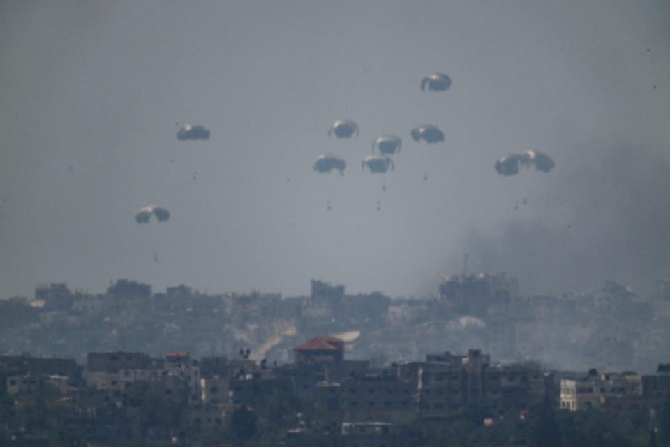 Parachutes drop supplies into the northern Gaza Strip as seen from southern Israel, Tuesday, April 9, 2024. (Associated Press)