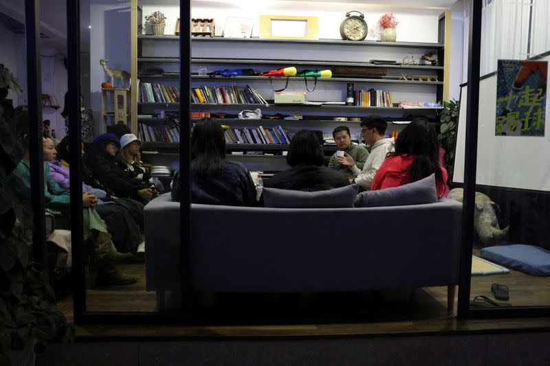 People attend a discussion session at a youth community hub in Dali