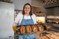 A baker Asia Olejniczak offers breads with a bolt sign as a ubiquitous symbol of the protests sweeping across Poland, in Warsaw