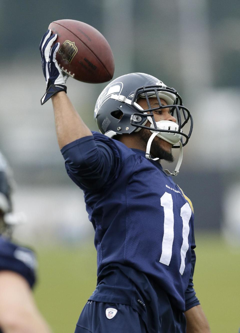 Seattle Seahawks NFL football wide receiver Percy Harvin catches a ball tossed to him during stretching warmups, Thursday, Jan. 2, 2014, before practice in Renton, Wash. (AP Photo/Ted S. Warren)