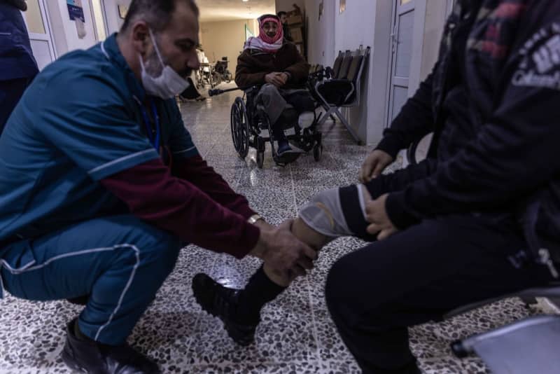 Patients with foot amputations train on prosthetic limbs at Aqrabat Specialized Hospital in Idlib Governorate after being injured in the 7.8-magnitude earthquake that struck southern Turkey and northern Syria on 06 February 2023. Anas Alkharboutli/dpa