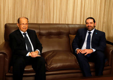 Christian politician and FPM founder Michel Aoun (L) sits next to Lebanon's former prime minister Saad al-Hariri after he said he will back Aoun to become president in Beirut, Lebanon October 20, 2016. REUTERS/Mohamed Azakir