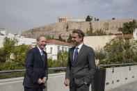 Microsoft President Brad Smith, left, speaks with Greek Prime Minister Kyriakos Mitsotakis during a ceremony held in the Acropolis Museum, in the background is the ancient Parthenon temple, central Athens, on Monday, Oct. 5, 2020. Microsoft has announced plans to build three data centers in greater Athens, providing a badly needed investment of up to $1 billion to the Greek economy which has been hammered by the pandemic. (AP Photo/Petros Giannakouris)