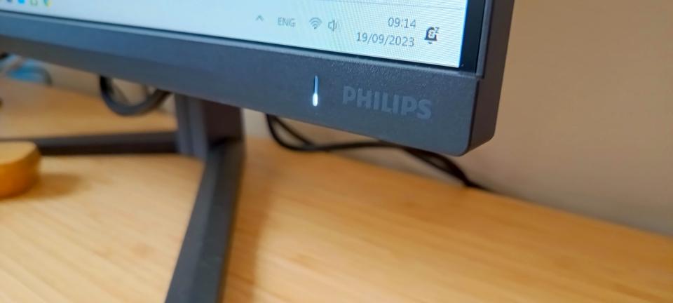 A dark slate Philips Evnia 25M2N5200P monitor on a wooden desk