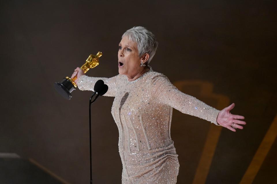 "Everything Everywhere" star Jamie Lee Curtis accepts the best supporting actress prize during Sunday's Academy Awards.