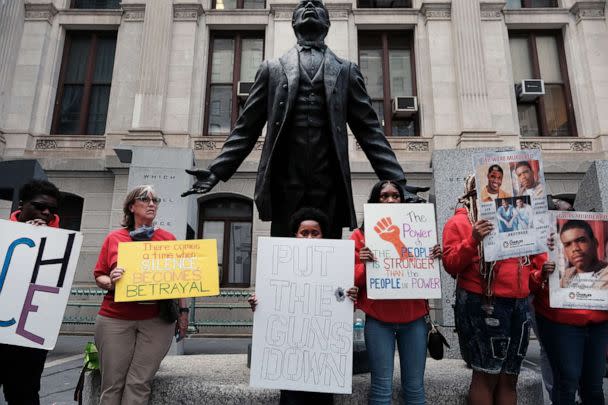 PHOTO: Teens hold up signs against violence as they participate in a 'Die In' to draw attention to gun violence, outside City Hall, Apr. 14, 2022, in Philadelphia. (Spencer Platt/Getty Images)